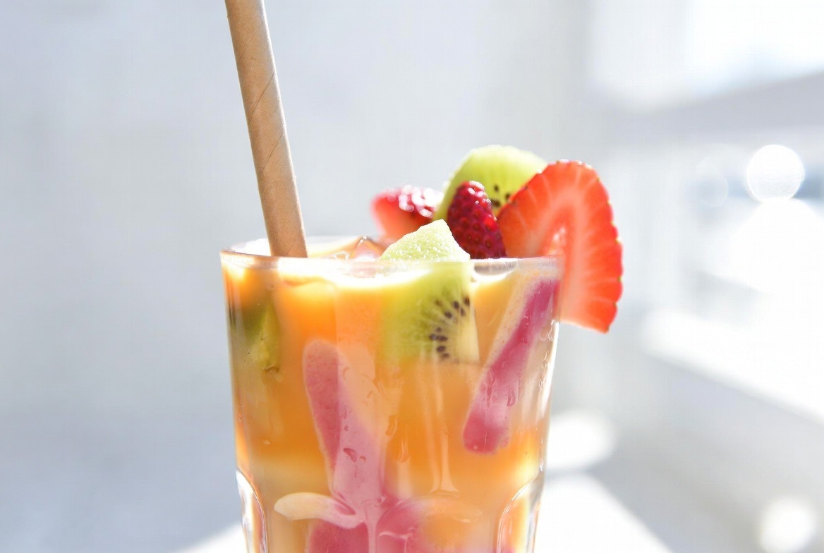Colorful smoothie drink with fresh fruit garnish